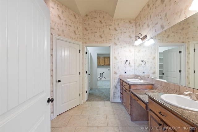 bathroom featuring lofted ceiling, tile patterned floors, and vanity