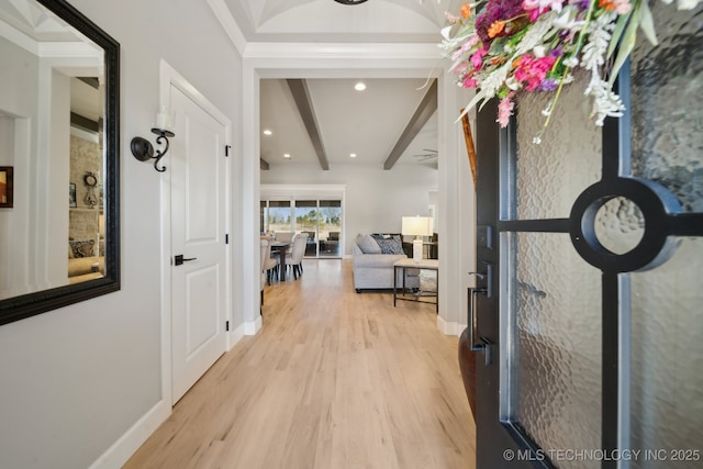 hallway with beam ceiling, light hardwood / wood-style flooring, and ornamental molding