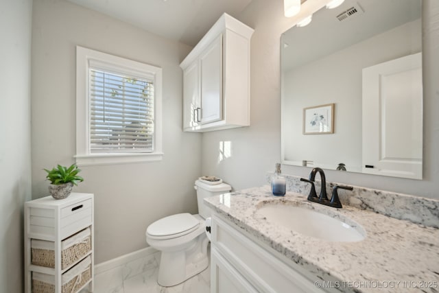 bathroom with vanity and toilet