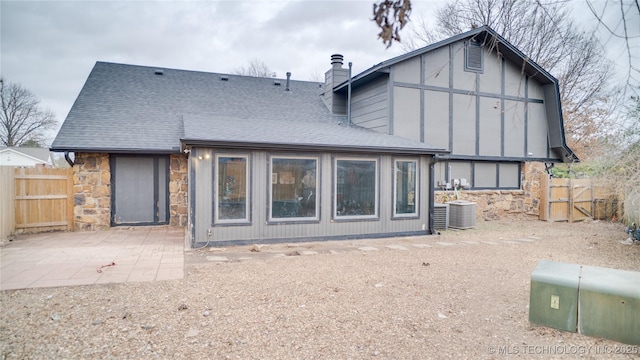 rear view of house with a patio area and central AC