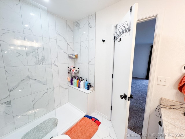 bathroom with a tile shower