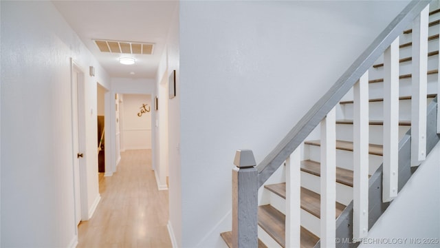 stairs featuring hardwood / wood-style floors