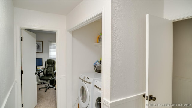 washroom with washing machine and dryer and light colored carpet