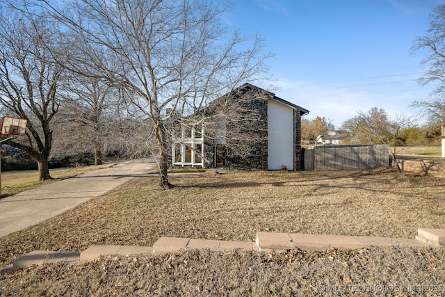 view of side of property featuring fence