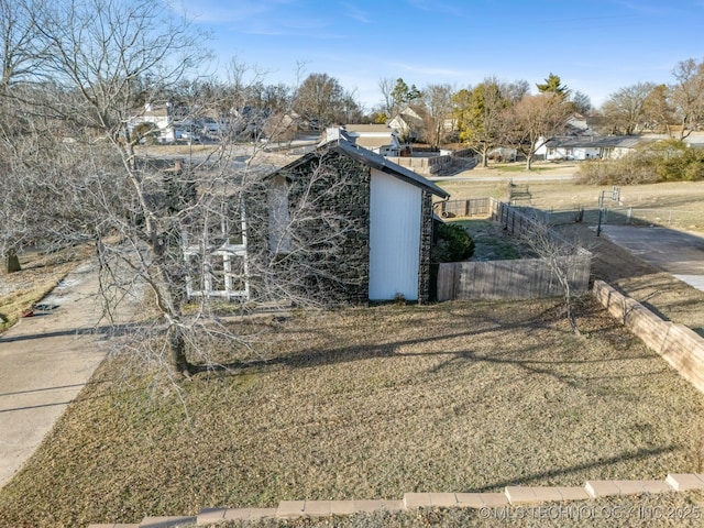 exterior space featuring a residential view and fence