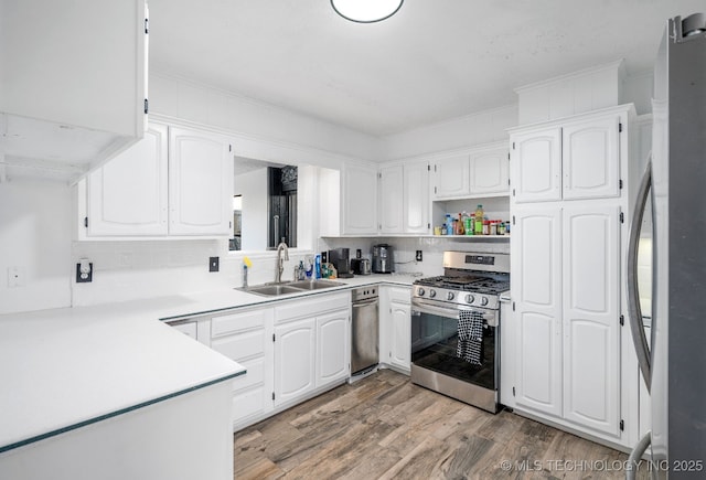 kitchen with open shelves, appliances with stainless steel finishes, a sink, and white cabinets