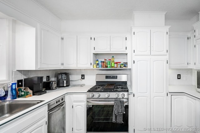 kitchen featuring white cabinets, light countertops, open shelves, tasteful backsplash, and gas range