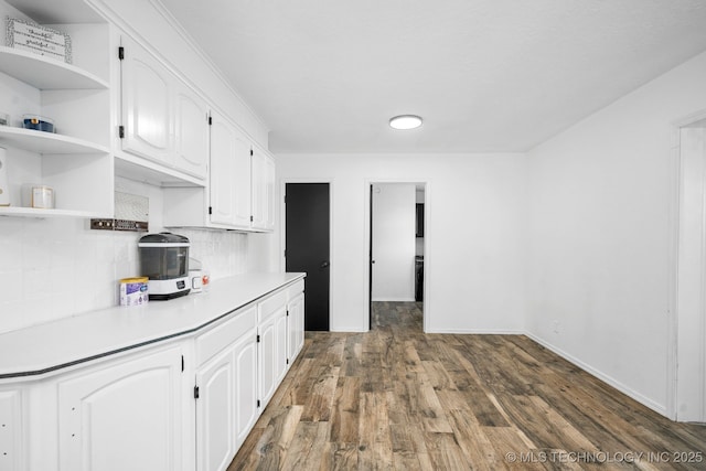 kitchen with dark wood-style floors, open shelves, tasteful backsplash, light countertops, and white cabinets