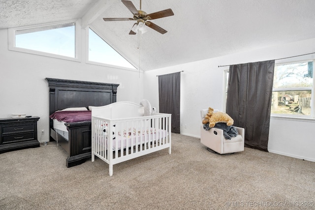 carpeted bedroom featuring vaulted ceiling with beams, ceiling fan, a textured ceiling, and baseboards