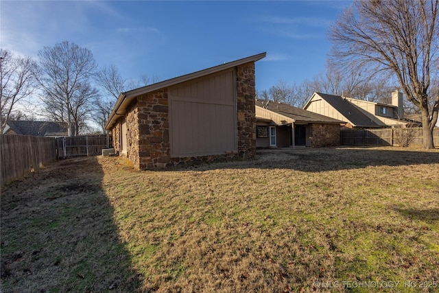 back of property featuring a lawn