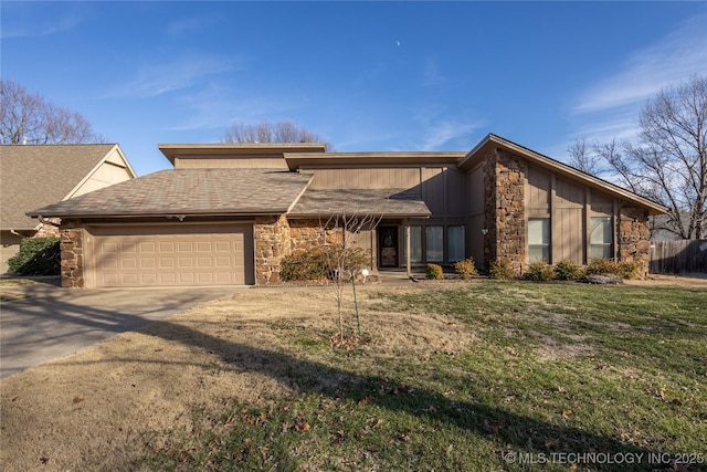 view of front of home with a front yard and a garage