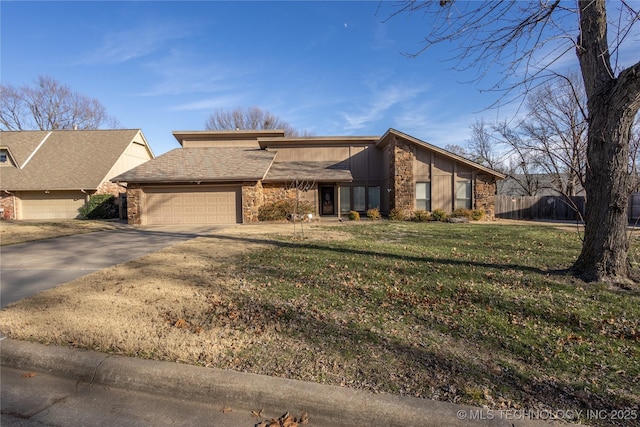 view of front facade with a garage and a front lawn