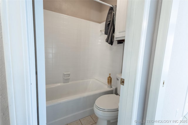 bathroom featuring tile patterned flooring, toilet, and bathtub / shower combination