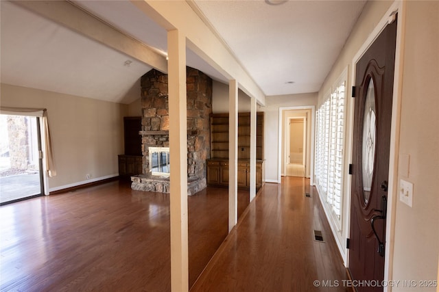 hall featuring dark hardwood / wood-style flooring and lofted ceiling with beams