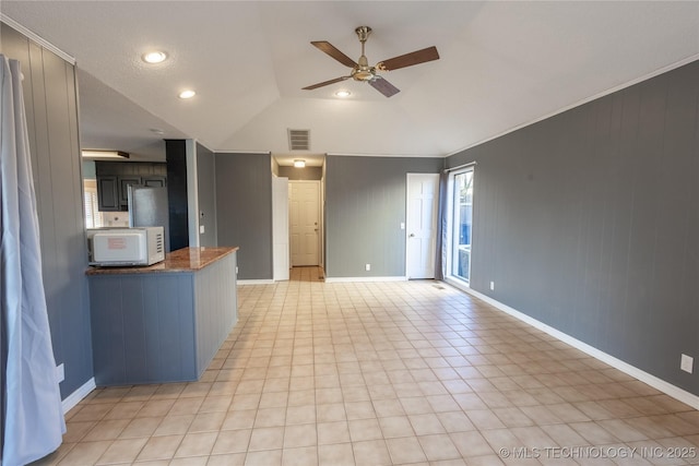 unfurnished living room featuring ceiling fan and vaulted ceiling