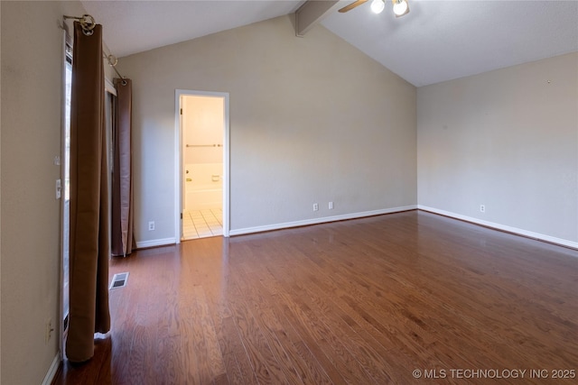 unfurnished room with dark wood-type flooring and lofted ceiling with beams