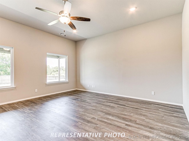 unfurnished room with ceiling fan and hardwood / wood-style floors