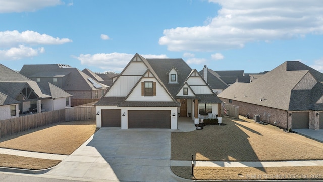 view of front of home with cooling unit and a garage