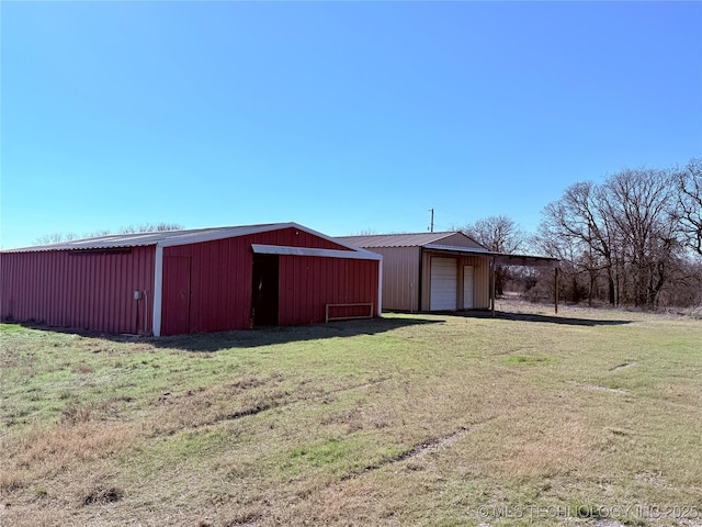 view of outdoor structure featuring a yard and a garage