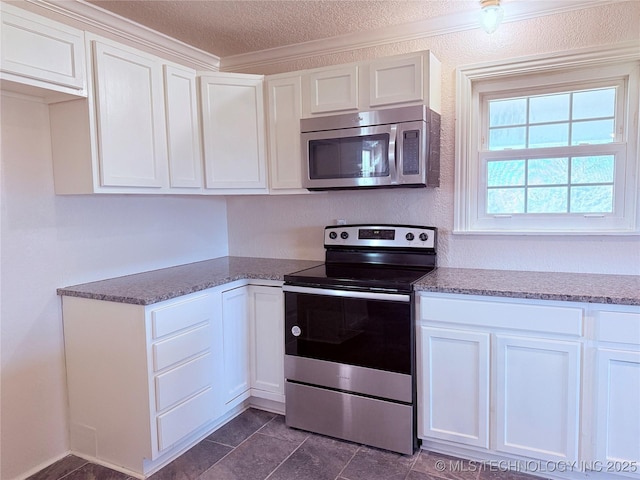 kitchen with white cabinets, stainless steel appliances, and stone counters