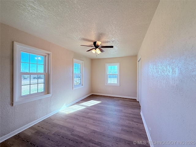 unfurnished room with a textured ceiling, ceiling fan, and dark hardwood / wood-style floors