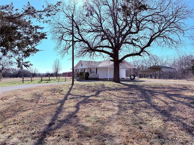 exterior space featuring a front yard and a carport