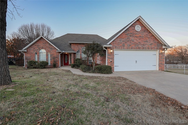 view of front of property featuring a yard and a garage