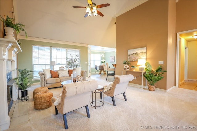 living room with light carpet, a towering ceiling, ceiling fan, and ornamental molding