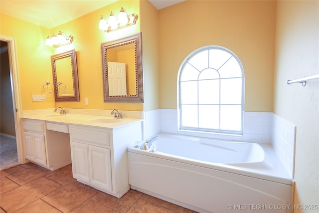 bathroom with a bathing tub, tile patterned flooring, and vanity