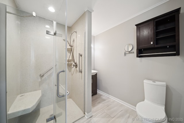 bathroom featuring vanity, toilet, and a shower with door