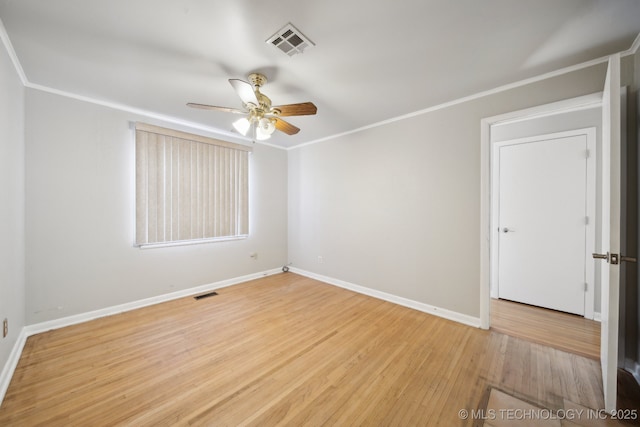 spare room with ceiling fan, crown molding, and light hardwood / wood-style floors