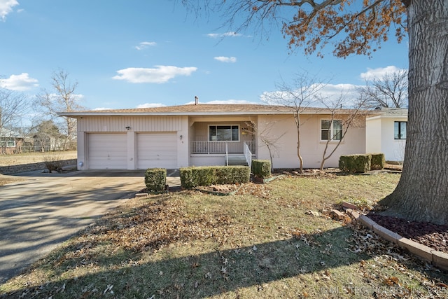 single story home with a garage and covered porch