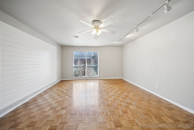 spare room featuring ceiling fan and rail lighting