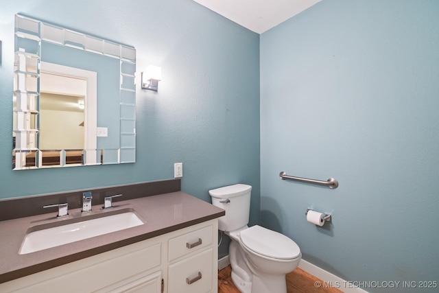 bathroom featuring vanity and toilet