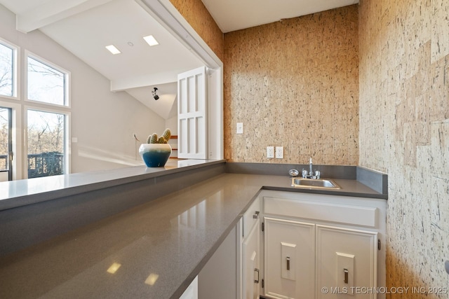 bathroom featuring vanity and lofted ceiling with beams