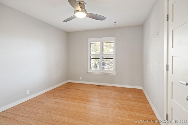 empty room with ceiling fan and light hardwood / wood-style floors