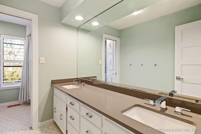 bathroom featuring tile patterned flooring and vanity