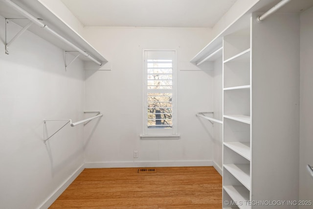 spacious closet featuring hardwood / wood-style floors