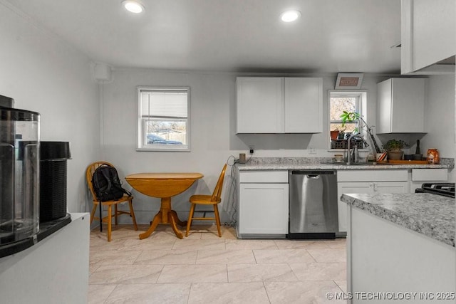 kitchen with stainless steel dishwasher, a healthy amount of sunlight, white cabinets, and sink