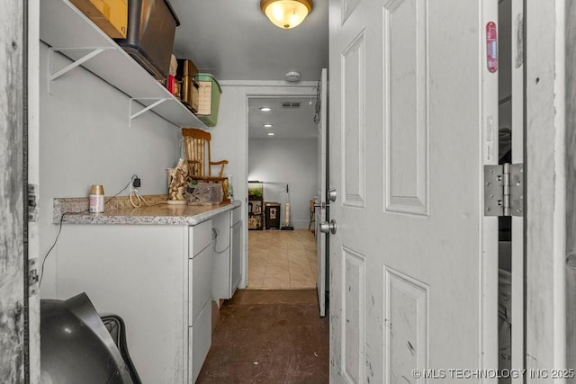 washroom featuring dark tile patterned flooring