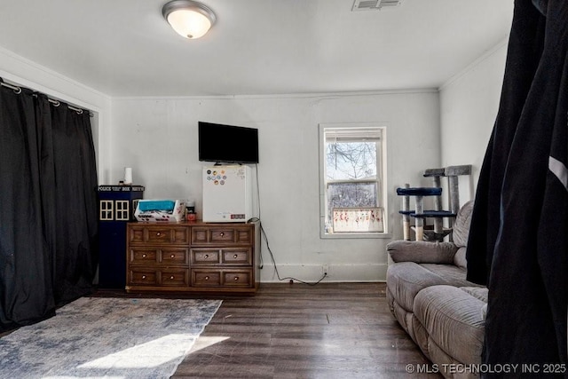 bedroom with dark hardwood / wood-style flooring and crown molding