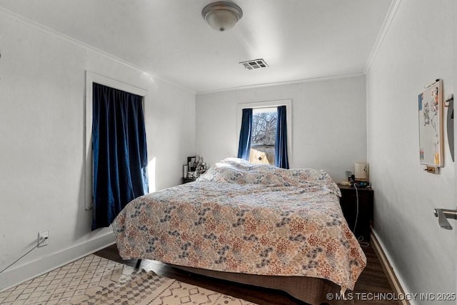 bedroom featuring crown molding and hardwood / wood-style floors