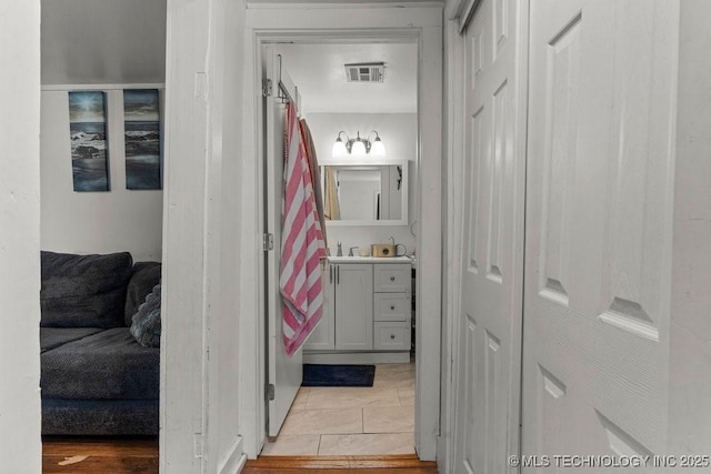 hallway with tile patterned floors