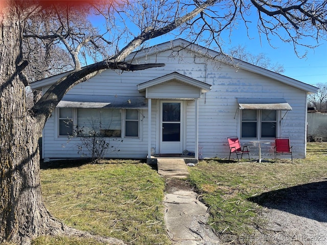 bungalow-style home with a front lawn