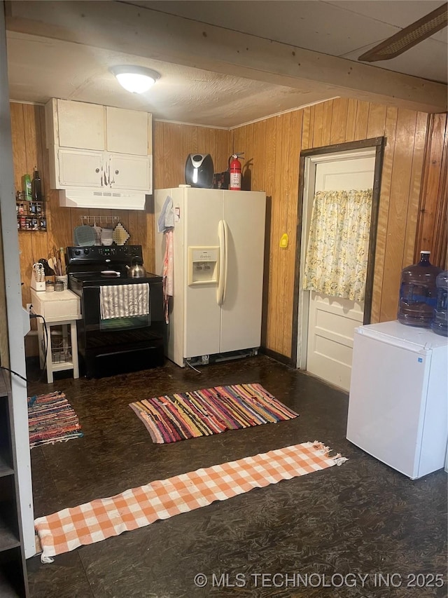 kitchen with white refrigerator with ice dispenser, black electric range oven, fridge, and wood walls