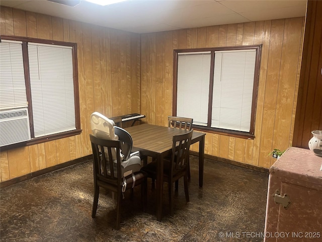 dining room featuring wood walls