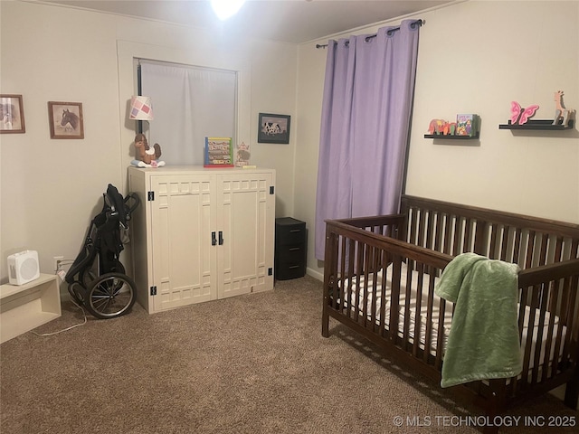 bedroom featuring a crib and carpet floors