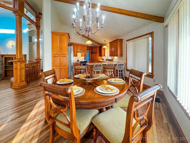 dining area featuring decorative columns, vaulted ceiling with beams, sink, a chandelier, and light wood-type flooring