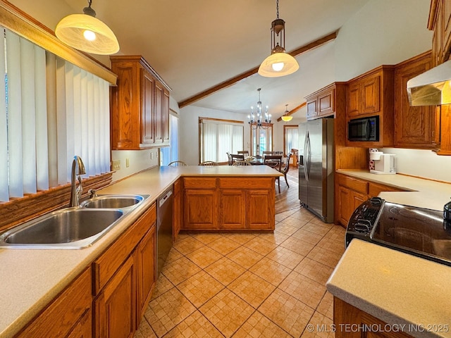 kitchen featuring stainless steel appliances, sink, a notable chandelier, and decorative light fixtures