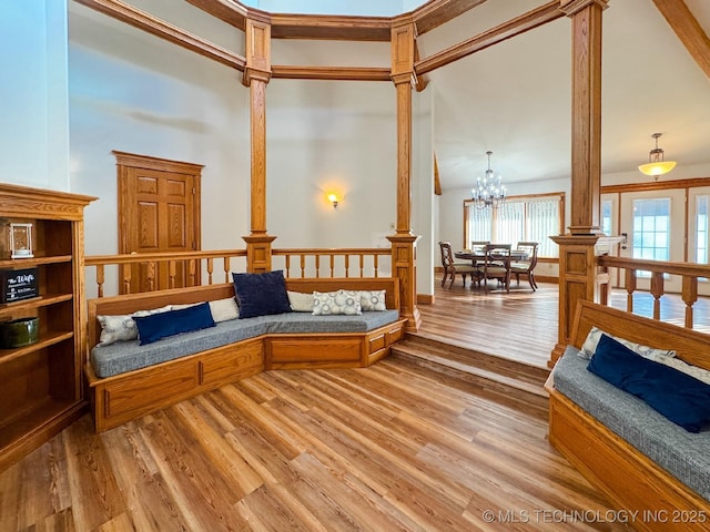 sitting room with hardwood / wood-style flooring and a chandelier